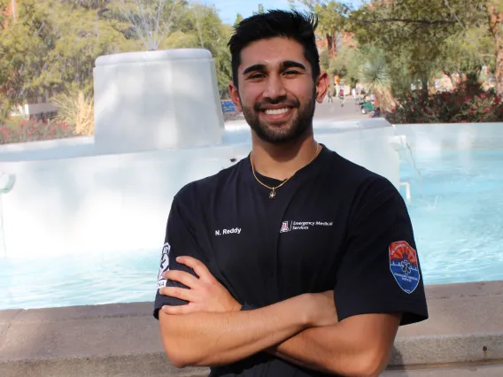 Nikhil in front of a fountain